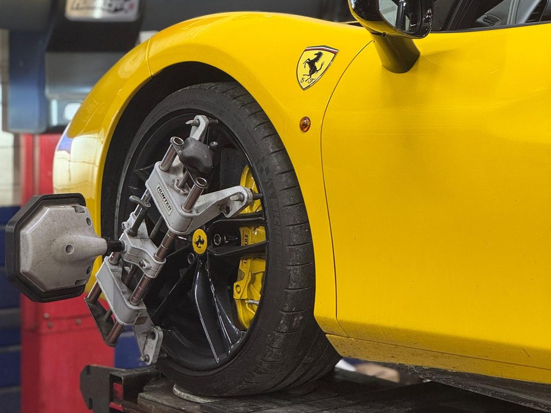 Tête de mesure Hunter fixée sur la roue avant d'une Ferrari 488 lors d'un réglage de géométrie — Formula Pneus Point S à Sens